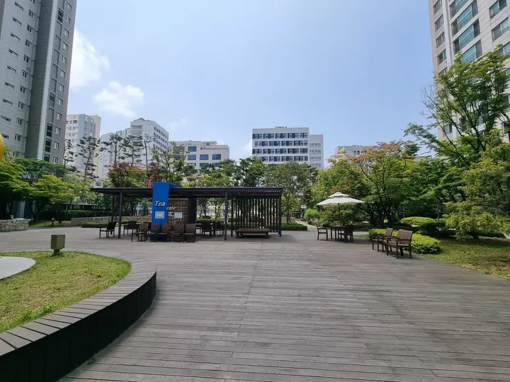 곡선 화단을 따라 이어진 데크 광장과 정자