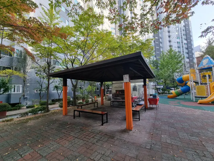 놀이터와 이어진 주황 기둥 퍼걸러