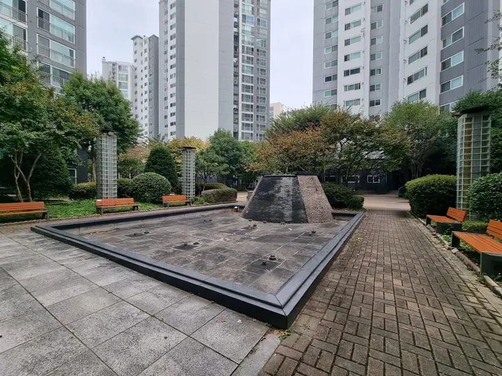 벤치를 두른 마른 분수대 광장